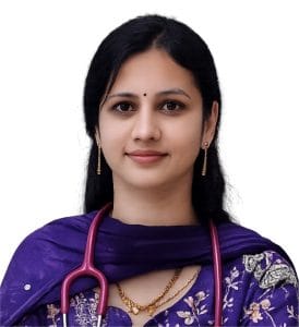 pathway hospital doctor peadatric dr shilpa - Pathway Hospital Portrait of a woman doctor with a stethoscope around her neck, wearing a purple traditional outfit and gold jewelry.