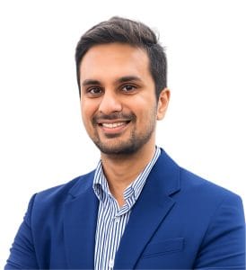 pathway hospital doctor ritesh plastic surgeon - Pathway Hospital Professional headshot: smiling man in a blue blazer and striped shirt looking at the camera.