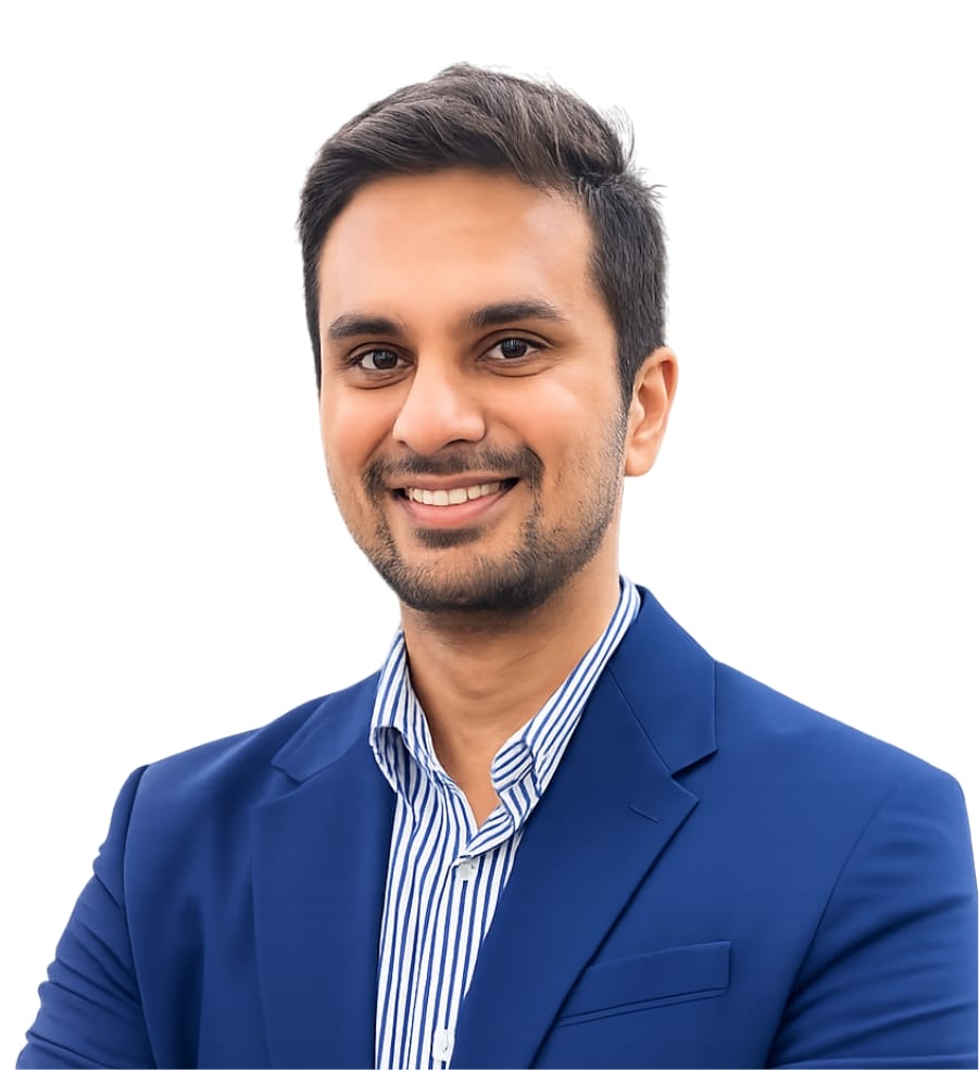 Professional headshot: smiling man in a blue blazer and striped shirt looking at the camera.
